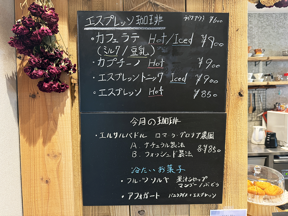カフェラテや今月の珈琲であるエルサルバドルなどが書かれたクロス珈琲館のメニュー黒板